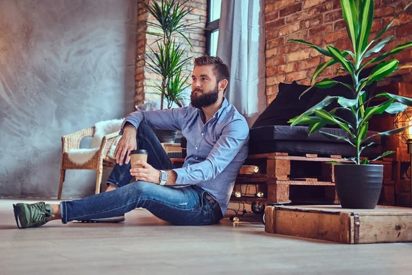 Man drinks coffee in a room