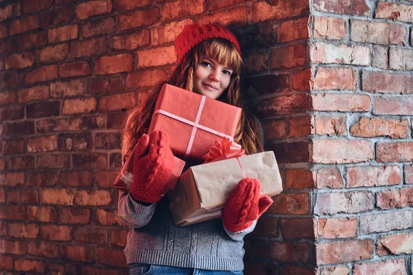 Redhead female holds Christmas gifts — Stock Photo, Image