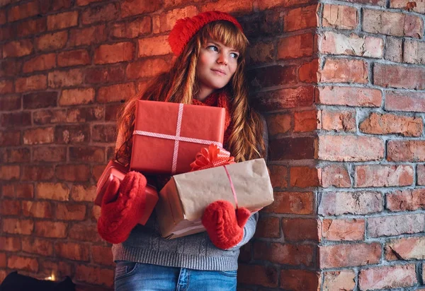 Redhead female holds Christmas gifts — Stock Photo, Image