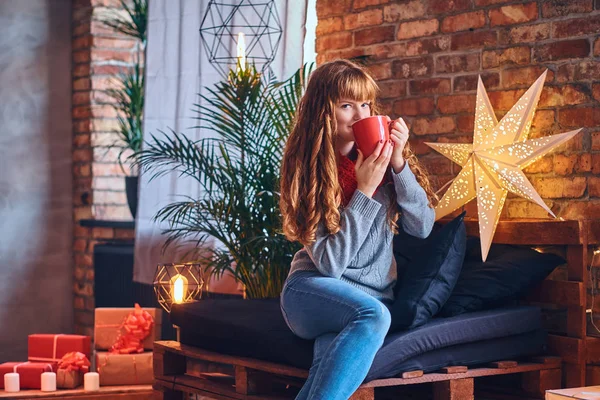 Redhead female drinks a hot coffee — Stock Photo, Image