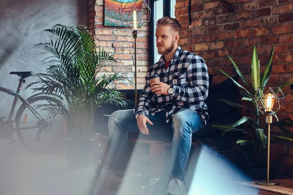 Man drinks coffee in a room