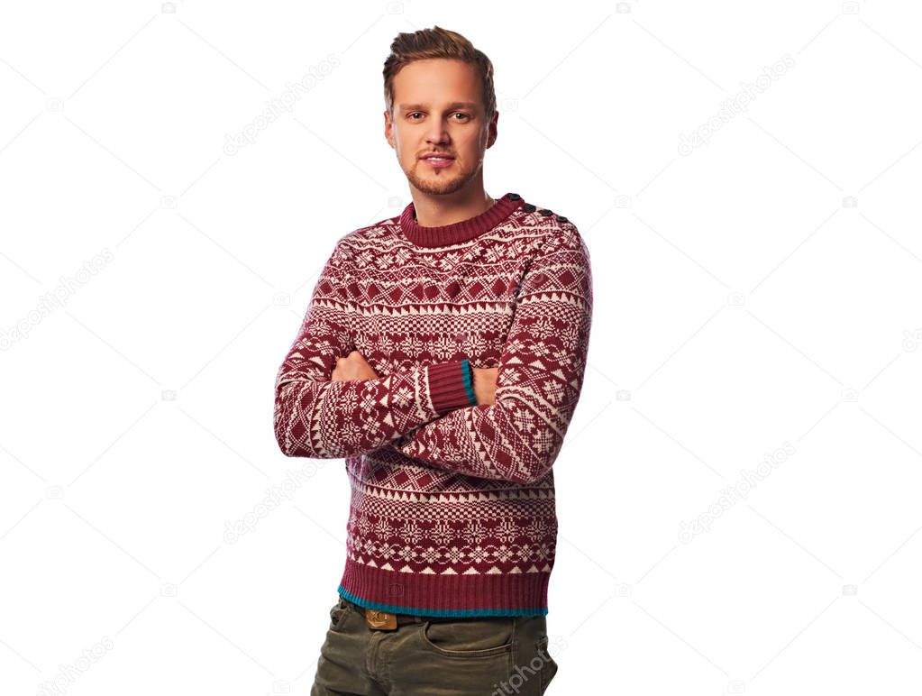 An attractive bearded male with crossed arms, dressed in a red sweater. Isolated on white background.