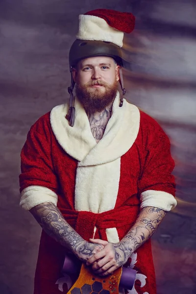 Ein Mann in Weihnachtsmannkleidung hält Longboard in der Hand. — Stockfoto