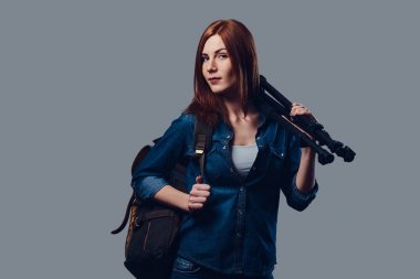 Bir kadın fotoğraf makinesi tutar.