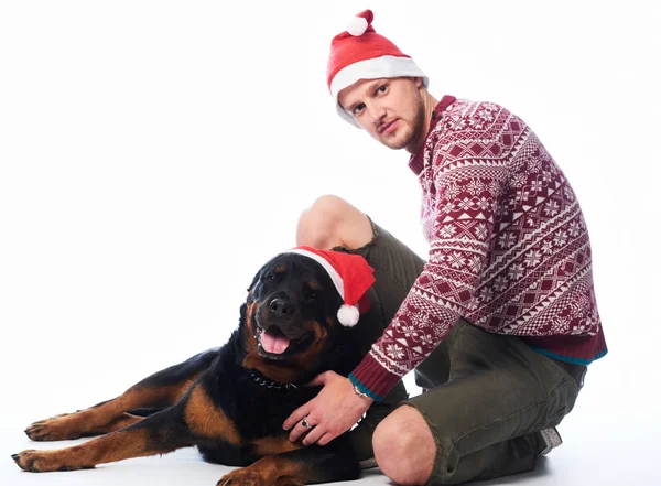 Man Dressed Wool Sweater Santa Hat His Rottweiler Dog Isolated — Stock Photo, Image