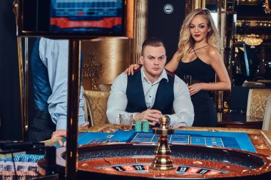 Çekici lüks çift bir Casino rulet oynamak.