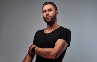 Sakal ve saç modeli tarafına seyir siyah t-shirt ile yakışıklı bir erkek.