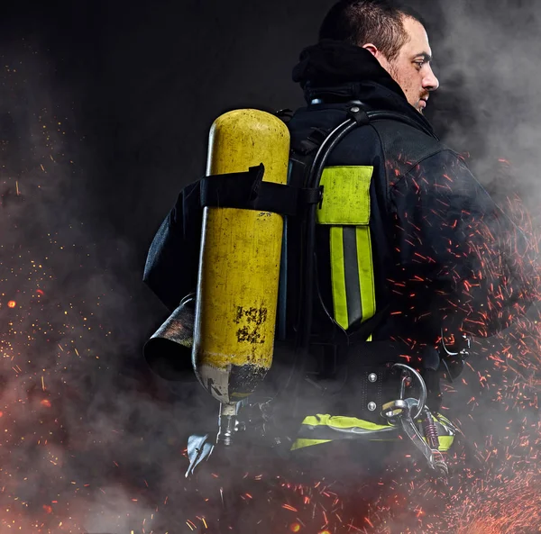 Firefighter Oxygen Tank His Back Standing Fire Sparks Smoke Dark — Stock Photo, Image