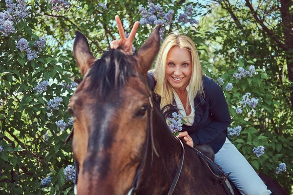 Happy Charming Blonde Jockey Riding Brown Horse Flower Garden — Stock Photo, Image