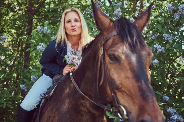 Charming Beautiful Blonde Jockey Riding Brown Horse Flower Garden — Stock Photo, Image