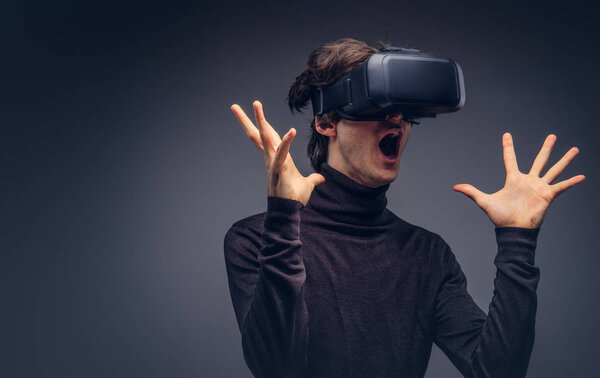 Studio portrait of a man wearing virtual reality device