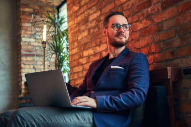 Çatı katı iç odadaki şık bir adam portresi.