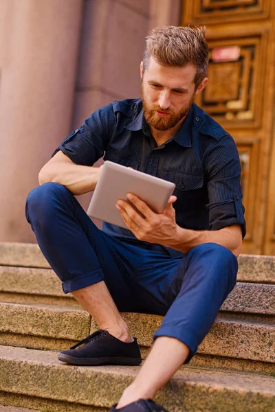 Handsome bearded male in casual clothes with the tablet computer — Stock Photo, Image
