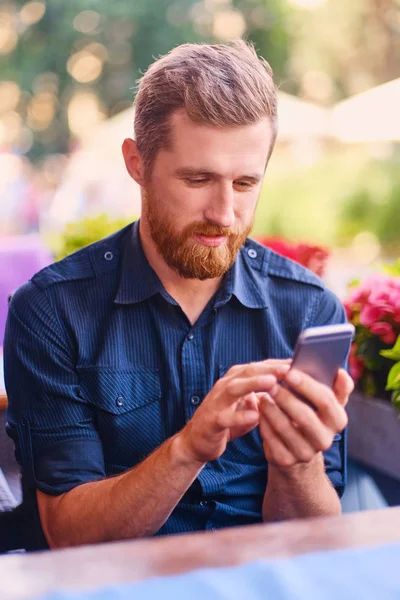 Outdoor shot of handsome bearded male dressed in casual clothing — Stock Photo, Image