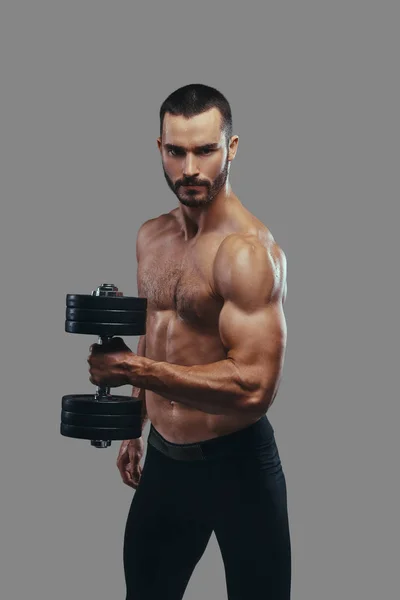 Brutal athletic bearded shirtless male doing exercise with dumbb — Stock Photo, Image