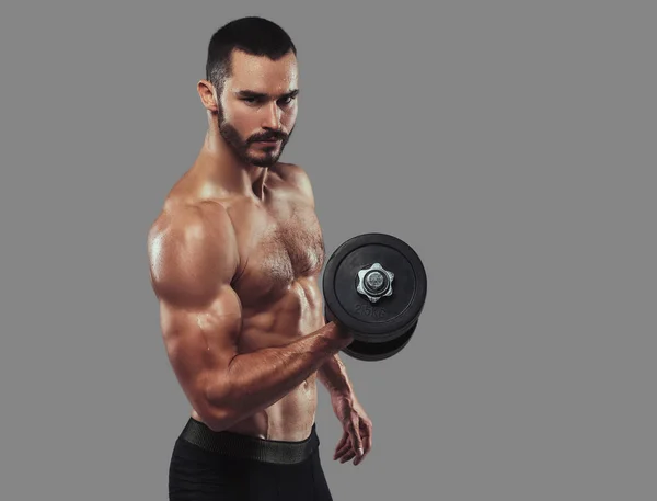 Brutal athletic bearded shirtless male doing exercise with dumbb — Stock Photo, Image