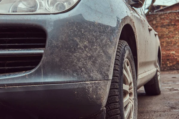 Close-up image of a dirty car after a trip off-road. Front view.