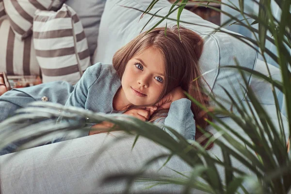 Portre Sevimli Bir Küçük Kızın Evde Kanepede Yatan Bir Kameraya — Stok fotoğraf