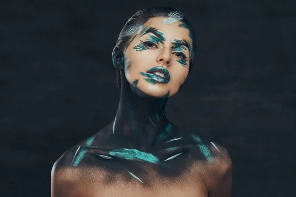 Ein junges sinnliches Mädchen mit kreativem Make-up. blaue und schwarze Schatten auf ihr Gesicht gemalt. Konzeptionelle Idee. — Stockfoto