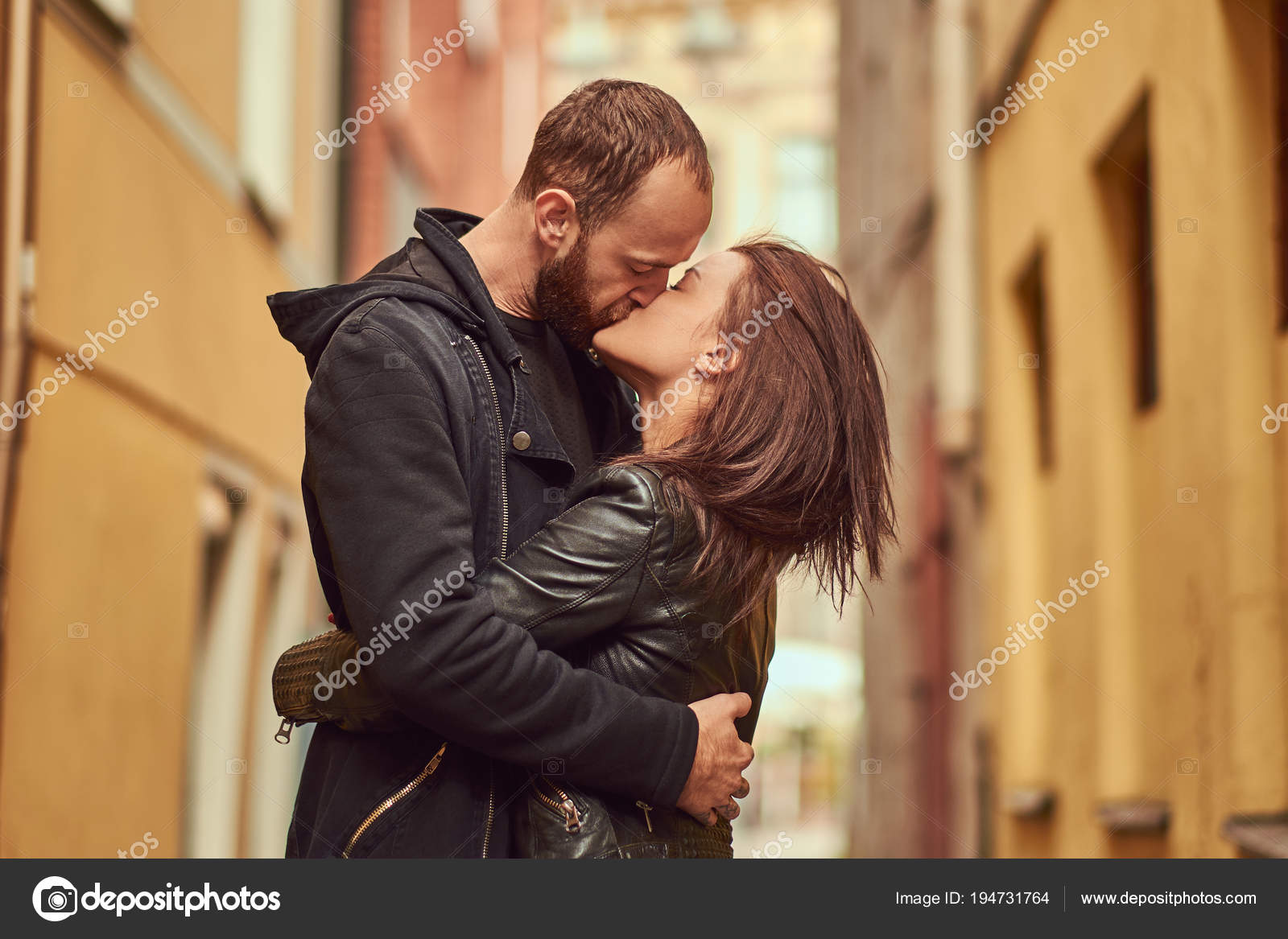 Naked men kissing a naked girl in the street