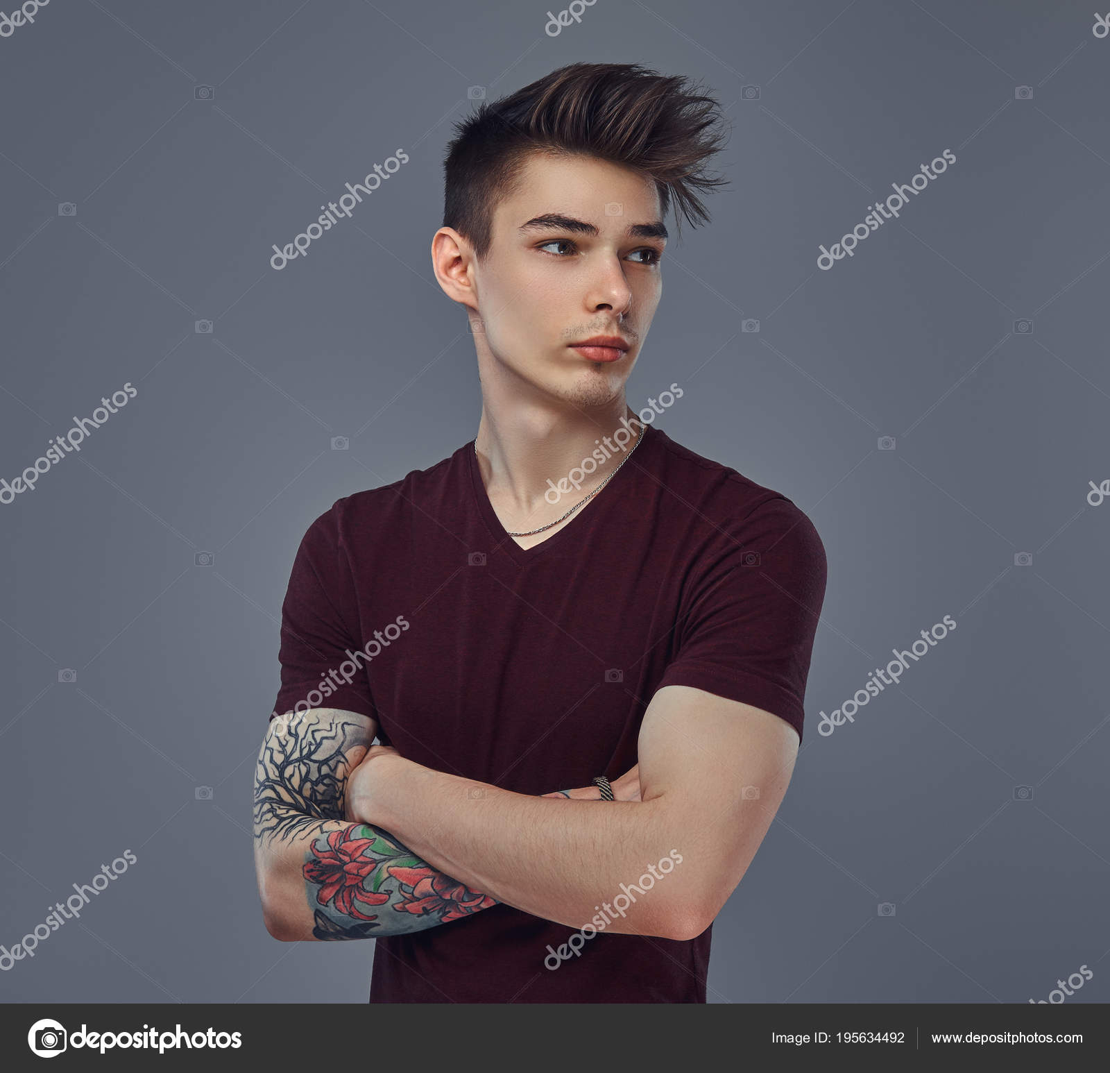 Handsome fashionable young guy with stylish hair and tattoo on his arm posing in a studio. Stock Photo by ©fxquadro 195634492 Handsome fashionable young guy with stylish hair and tattoo on his arm posing in a studio. Stock Photo by ©fxquadro 195634492