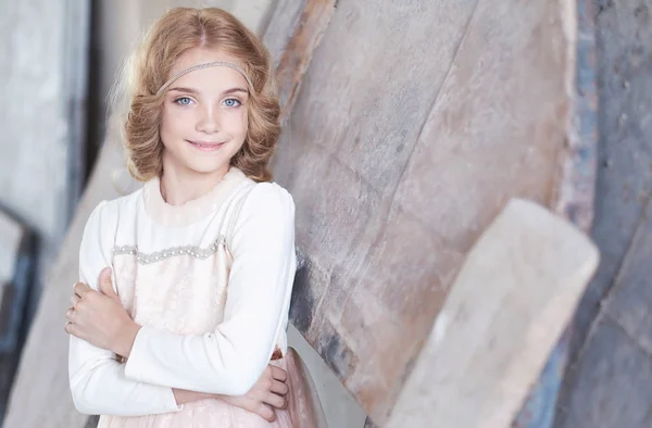 Happy little girl model with charming smile posing in a studio. — Stock Photo, Image