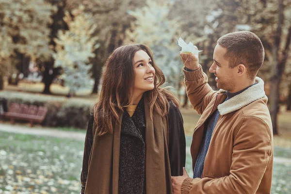 Romantic couple have fun with autumn leaf — Stock Photo, Image