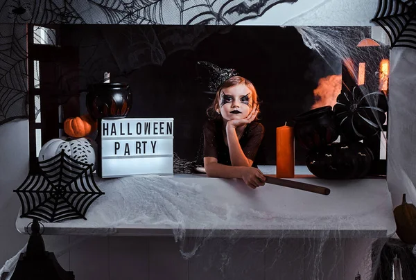 Portrait of cool little witch with Halloween decorations — Stock Photo, Image