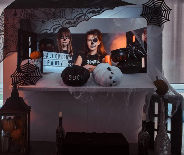 Two friends with scary makeup are posing for photographer