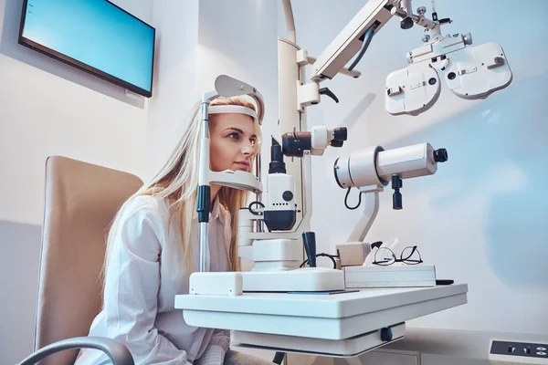 Vrouw controleert haar zicht bij opticien kabinet — Stockfoto