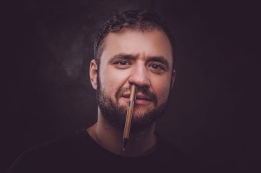 Man with pen in his nose