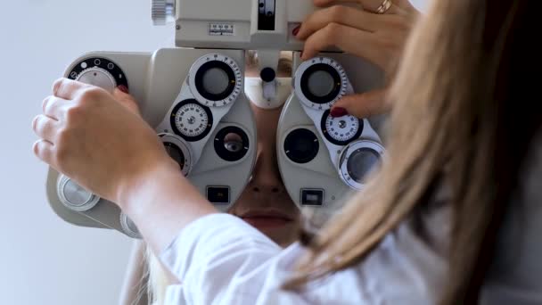 Oculist controleert de ogen van patiënten — Stockvideo