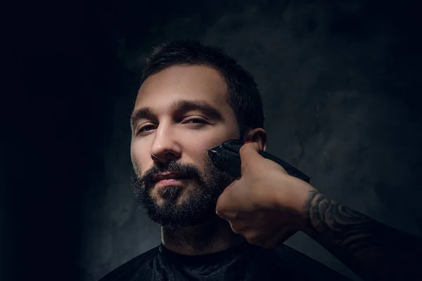Portrait of male, wich gets a beard care from woman — Stock Photo, Image