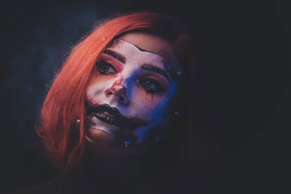 Portrait of ginger girl with scary doll art on face — Stock Photo, Image