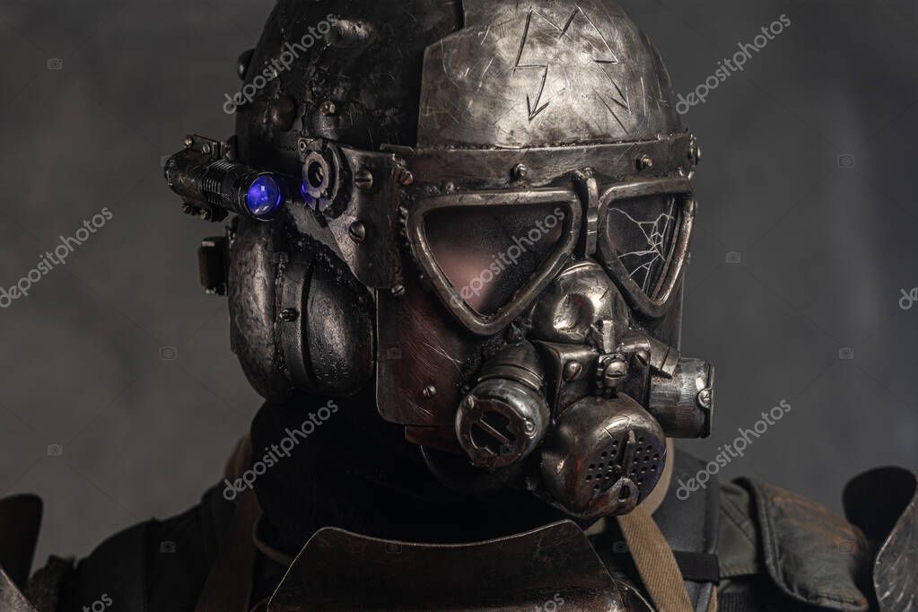 Close up photo shoot of man in helmet with gas mask and small flash light on side.