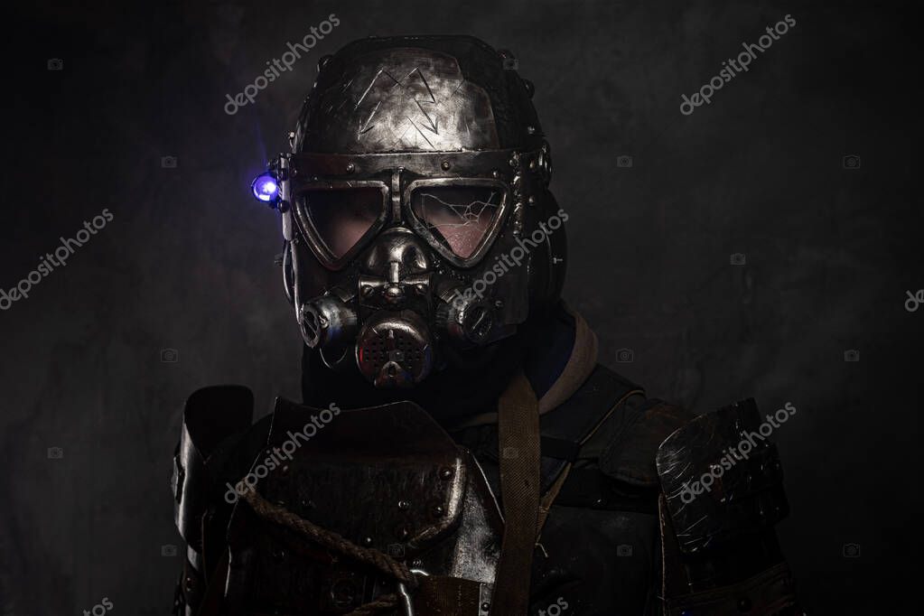 Close up photo shoot of man in helmet with gas mask and small flash light on side.