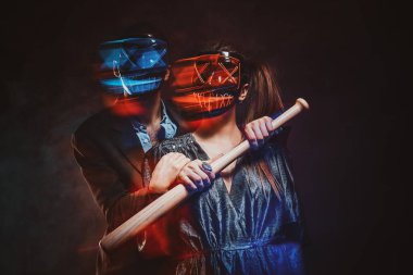 Portrait of crazy couple in masks with bat clipart