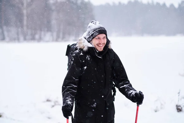 Ragazzo felice che fa trekking accanto a una foresta innevata — Foto Stock