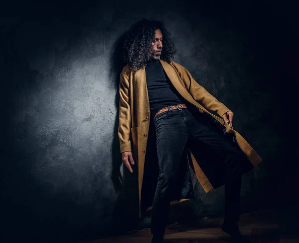 Portrait of curly long haired man at photo studio — Stock Photo, Image