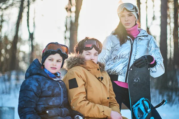 Familia amigable con snowboard en el bosque de invierno — Foto de Stock