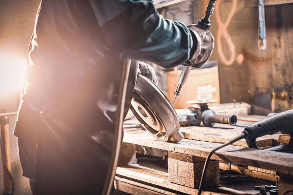 Busy man is working on metal factory