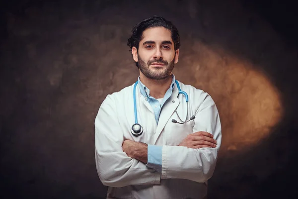 Portrait of smart handsome doctor over dark background. — Stock Photo, Image