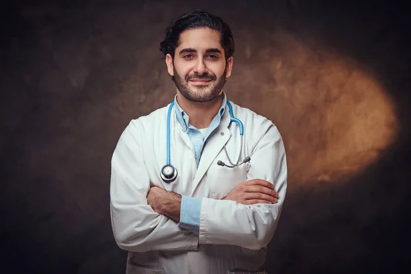 Portrait of smart handsome doctor over dark background. — Stock Photo, Image