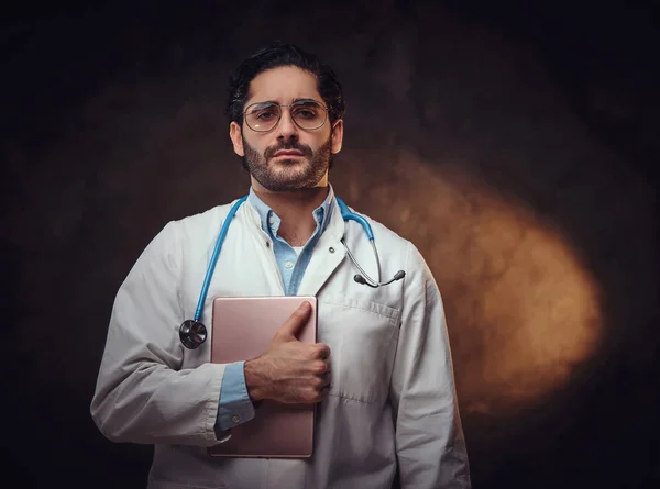 Portrait of focused doctor with tablet in hands
