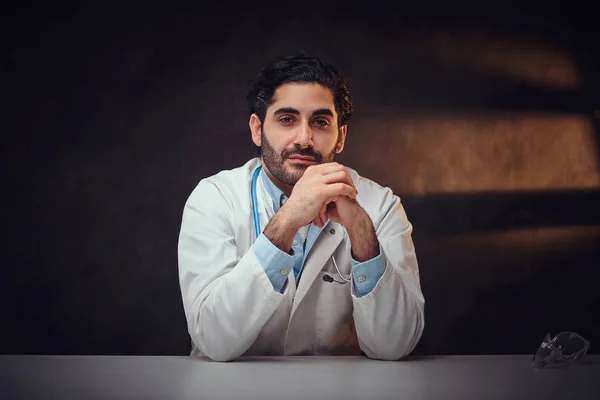 Tired student intern is sitting next to the table — Stock Photo, Image