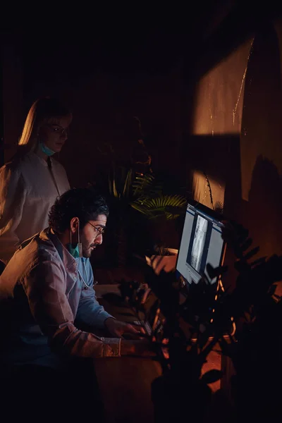 Two docters are working in the dark office — 스톡 사진