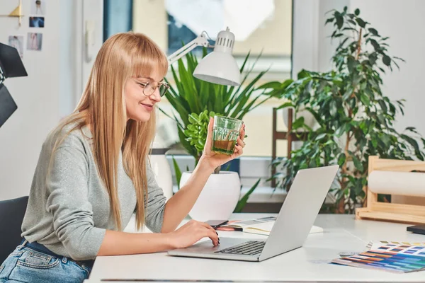 Sorrindo mulher está trabalhando no computador — Fotografia de Stock