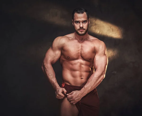 Young shirtless bodybuilder has a photo session — Stock Photo, Image