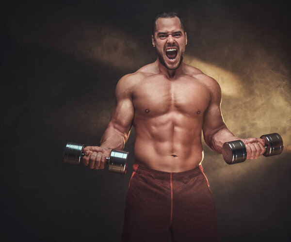 Young shirtless bodybuilder has a photo session