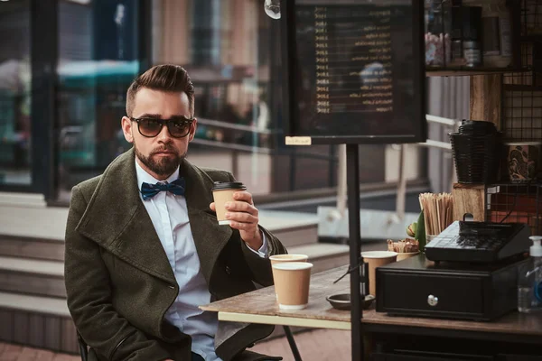 Stylish male customer sitting outdoors next to coffee making gear in a mobile coffee shop in a city emporium — Stock Photo, Image